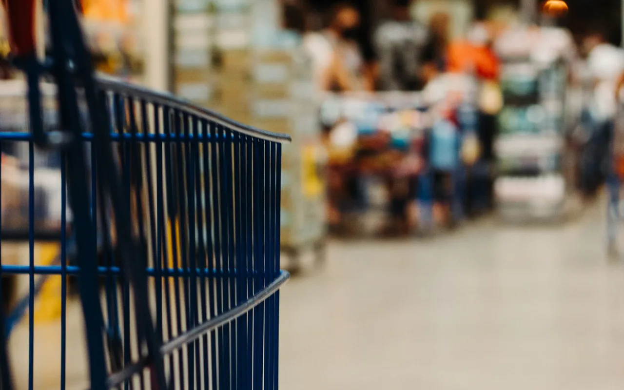 A shopping cart in a supermarket aisle